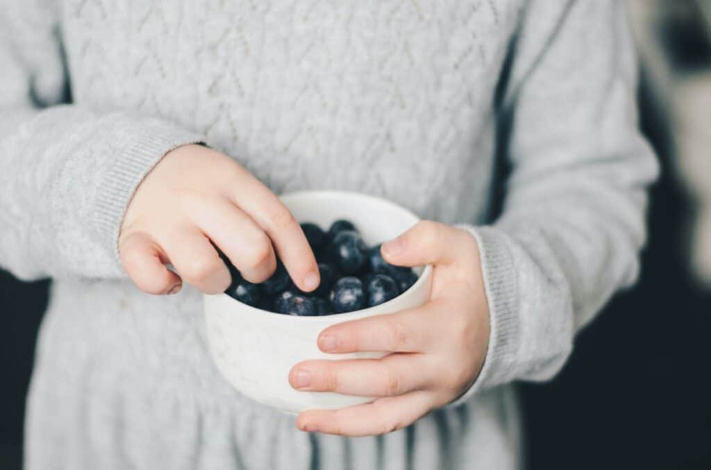 Child with blueberries, snacks